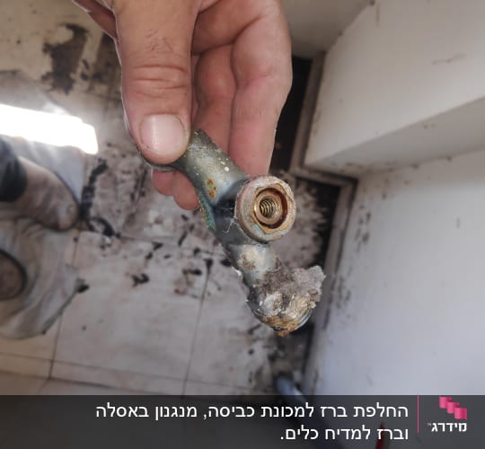 יד מחזיקה צינור מתכת חלוד עם לכלוך